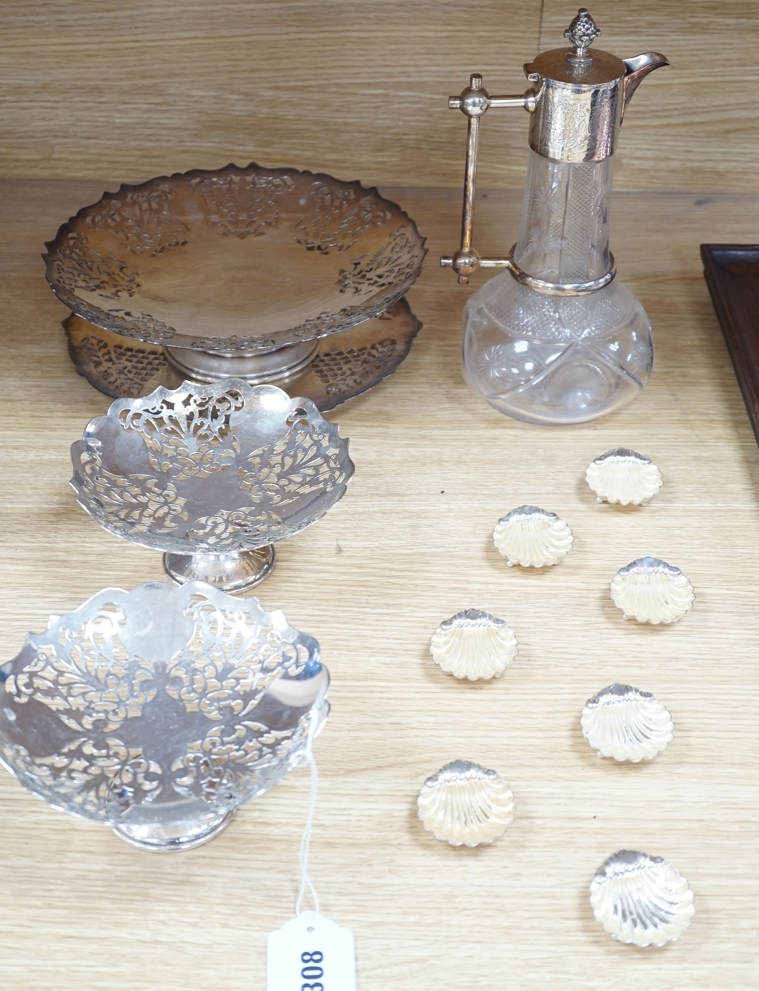 A late Victorian plate mounted cut glass claret jug of onion shape, height 25.6cm a graduated set of plated compotes, pierced circular dish tops, on pedestal stems, makers Mappin & Webb, largest diameter 24.5cm and six p